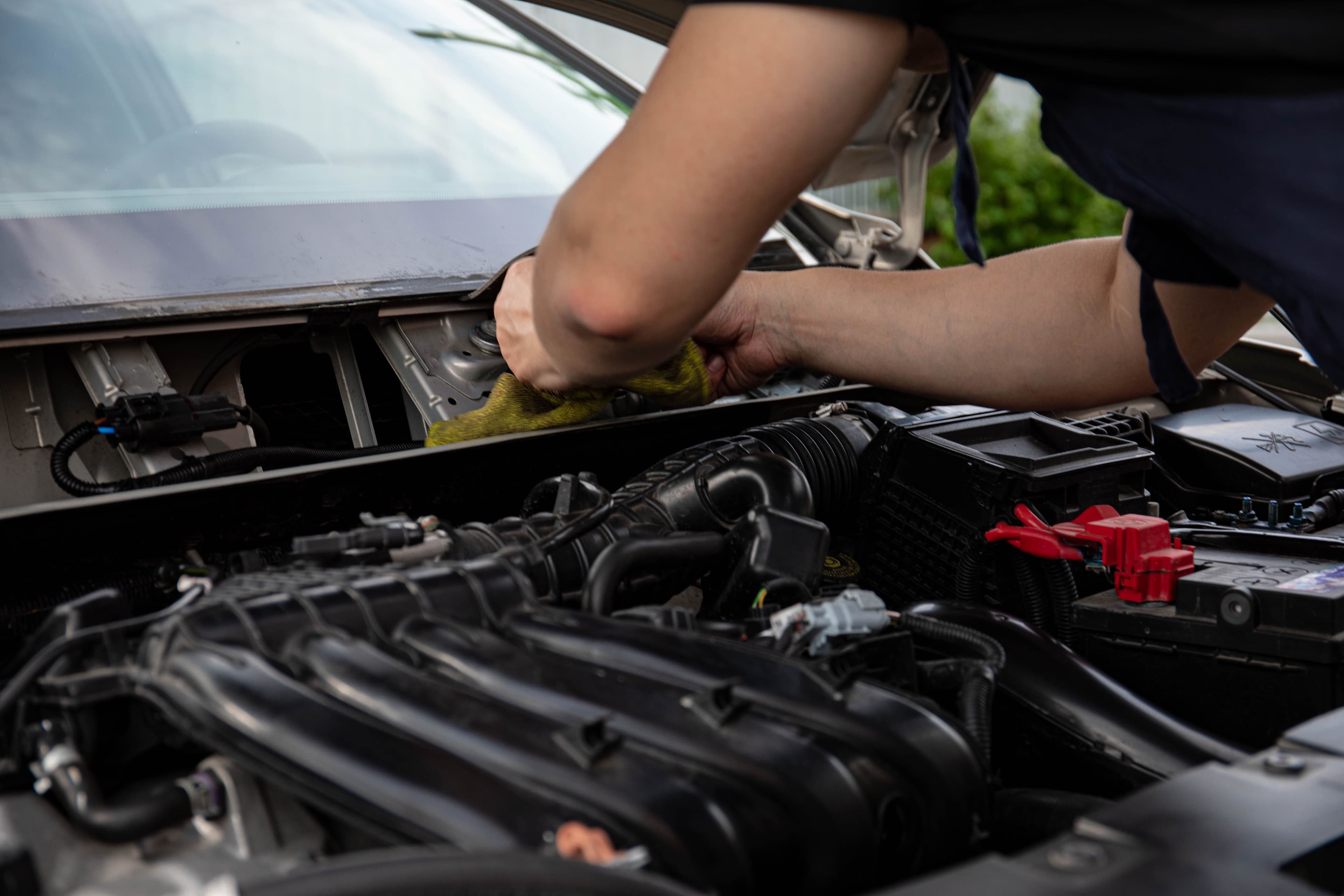 Mechanic working under the bonnet of a car